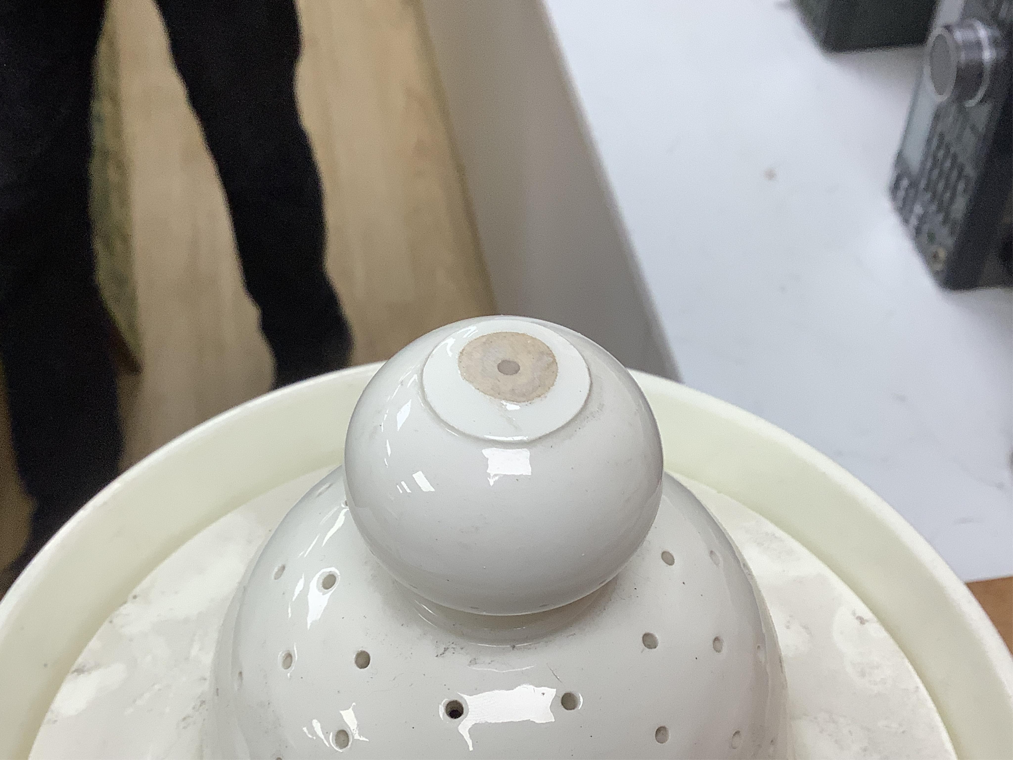 A Victorian pottery pedestal leeches jar and pierced cover, with the remains of the painted word ‘leeches’ around the body of the jar, 30.5cm high